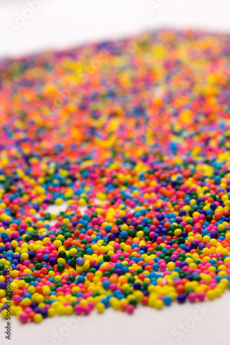 This is a background of colorful neon colored round sprinkles background © dana_zurki