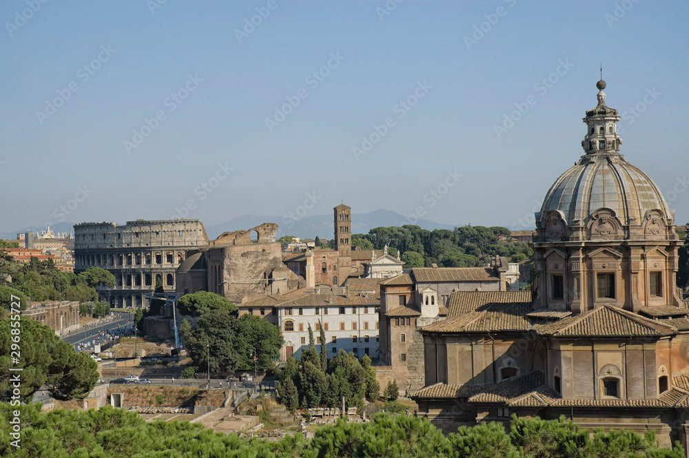 Rome rooftops and hills seen from the Forum with distant view of the Colosseum 
