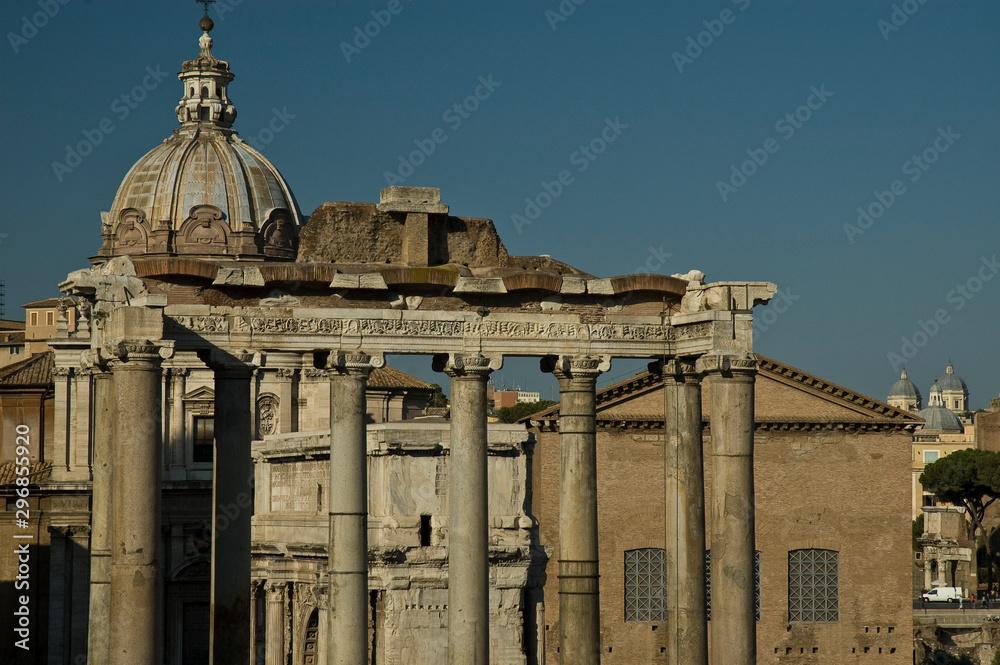 Columns of the temple of Saturn in the Roman Forum and dome of the Church Chiesa Santi di Luca e Martina, Rome, Italy