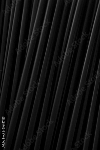 This is a photograph of Black plastic straws