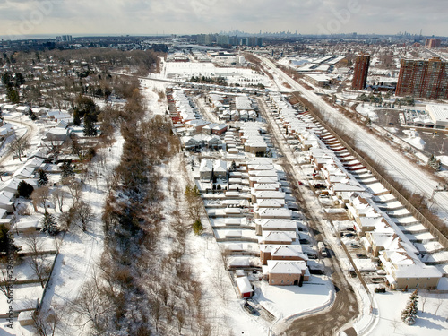 Aerial view of the city. Hundreds of houses bird eye top view suburb urban housing development. Quite neighbourhood covered in snow, Canada. Winter season. photo