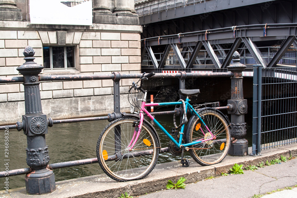 BERLIN, GERMANY - May 15, 2014. Broken forgotten bicycle on the bridge in Berlin.