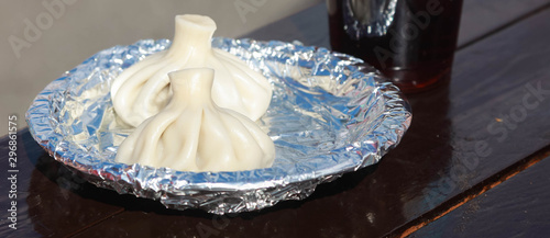 Traditional Georgian khinkali with meat on a foil plate