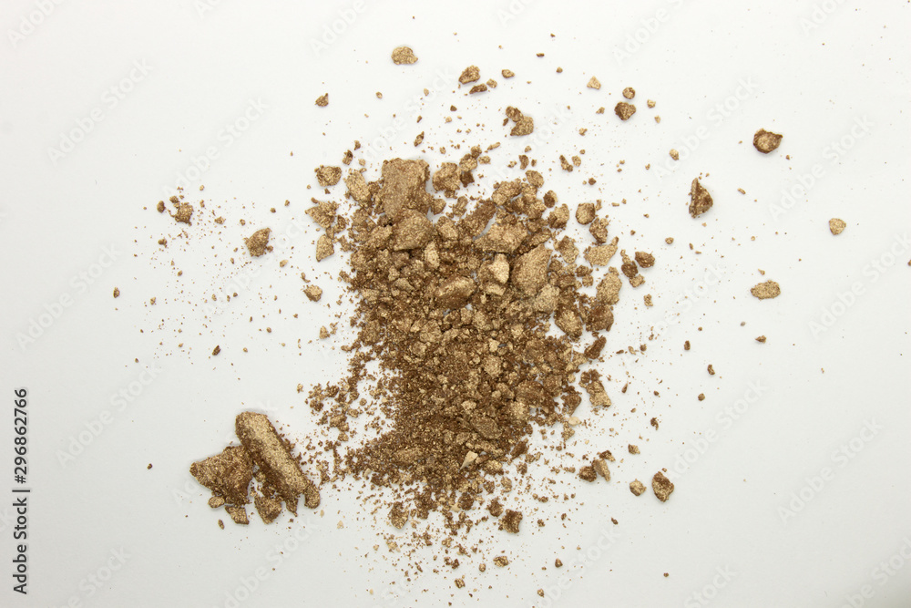 This is a photograph of a shimmery golden powder eyeshadow isolated on a White background