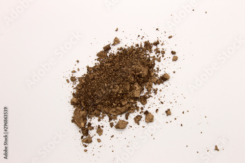 This is a photograph of a Brown powder eyeshadow isolated on a White background