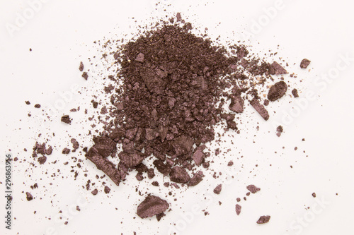 This is a photograph of a Dark Purple powder Eyeshadow isolated on a White background