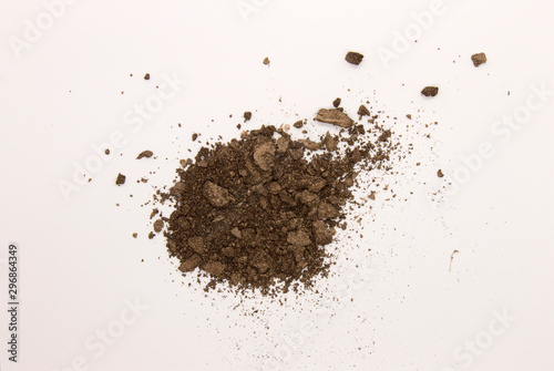 This is a photograph of a Dark Brown powder Eyeshadow isolated on a White background