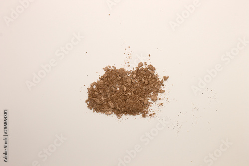 This is a photograph of a Copper powder Eyeshadow isolated on a White background