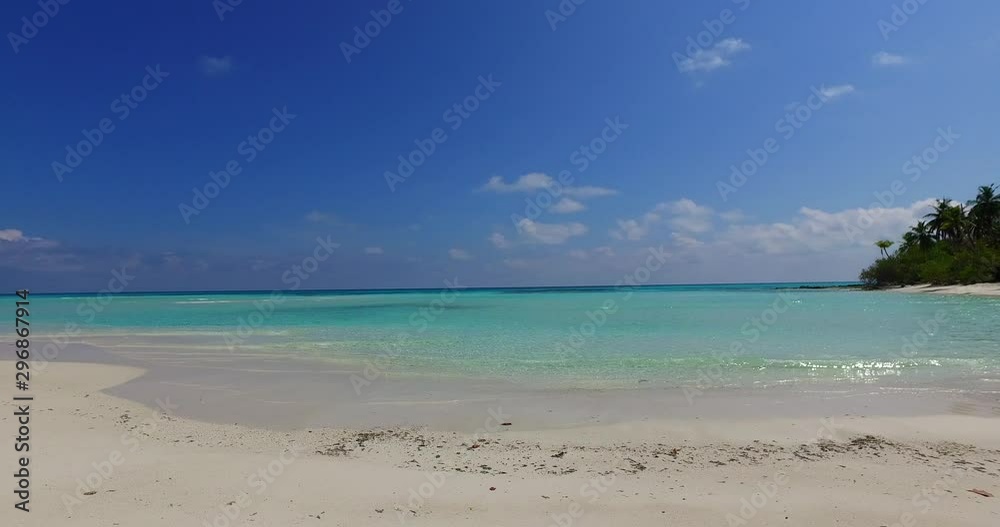 Horizontal pan view of a turquoise lagoon washing white sand beach in Pulau Sebatik island, Malaysia Horizontal pan view of a turquoise lagoon washing white sand beach in Pulau Sebatik island, Malaysia