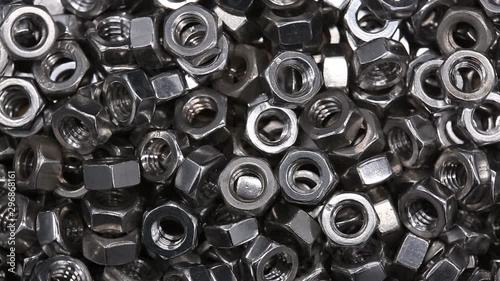 Close up a bunch of metal nuts for industrial needs. Metal products.