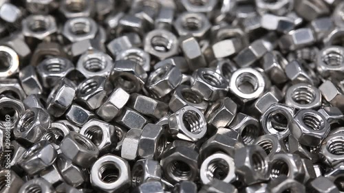 Close up a bunch of metal nuts for industrial needs. Metal products.