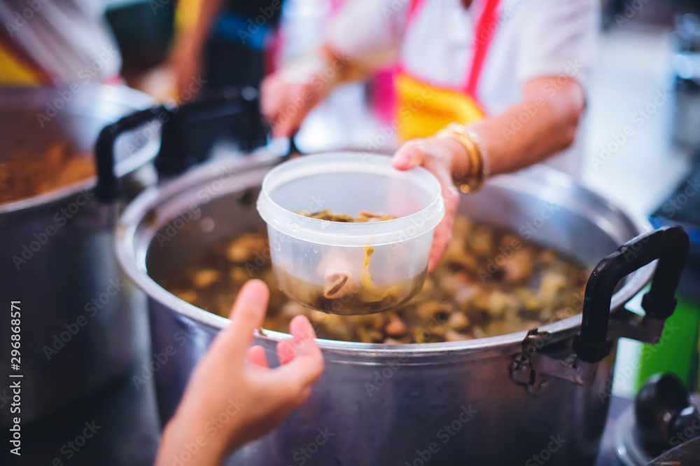 Volunteers give away free food to hungry people : concept of care And feeding Volunteers give away free food to hungry people : concept of care And feeding