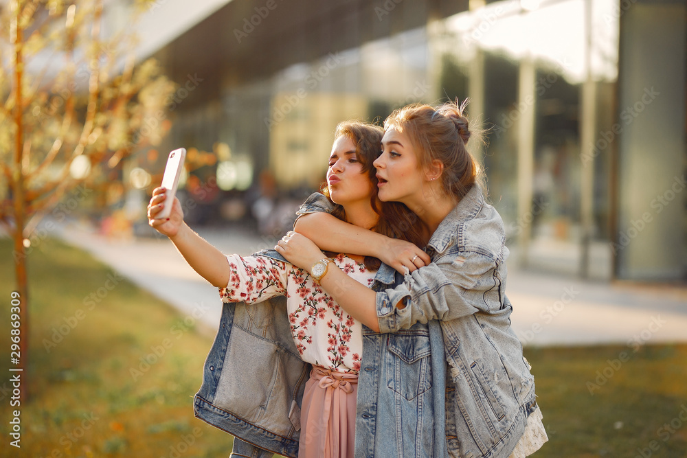 Naklejka premium Girl in a blue jacket. Women in a summer park.
