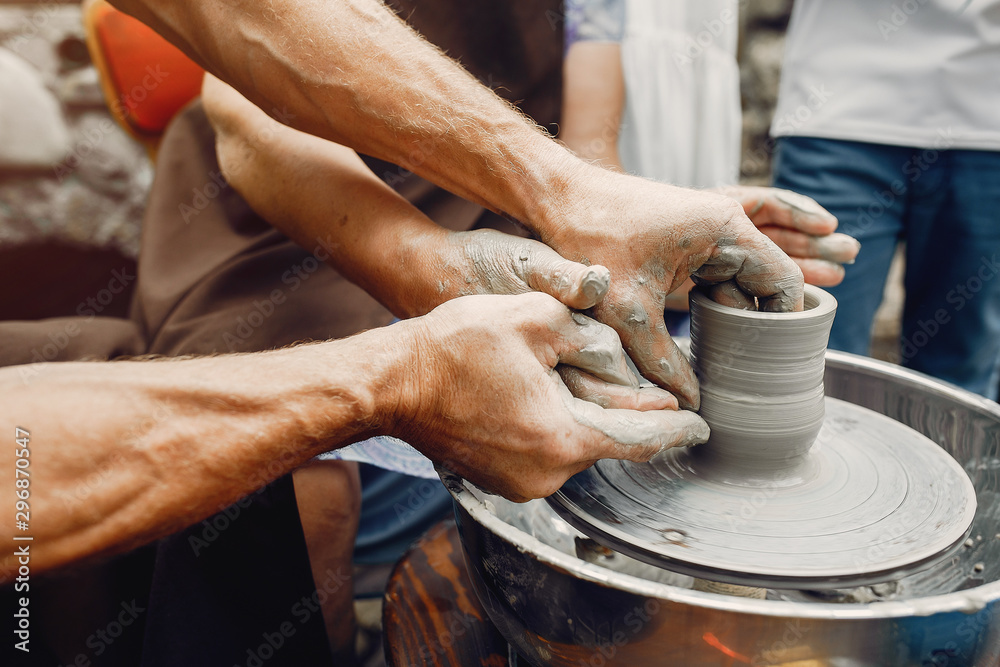 Potter make a small jug. Hands of a potter at work Potter make a small jug. Hands of a potter at work