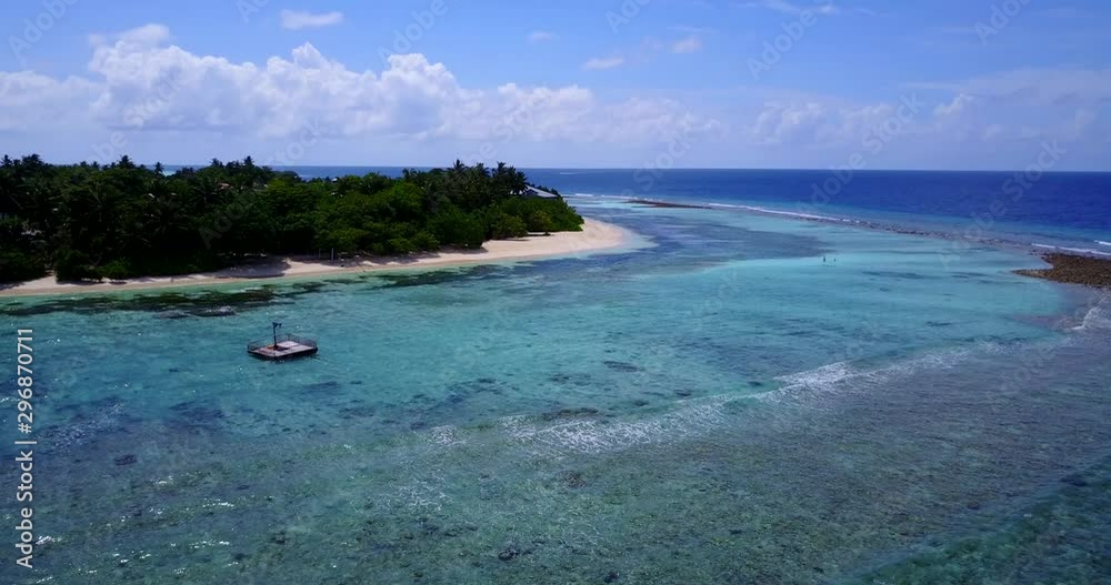 Aerial descending drone view on a colorful coastline of tropical island, swimming platform floating on turquoise water Aerial descending drone view on a colorful coastline of tropical island, swimming platform floating on turquoise water