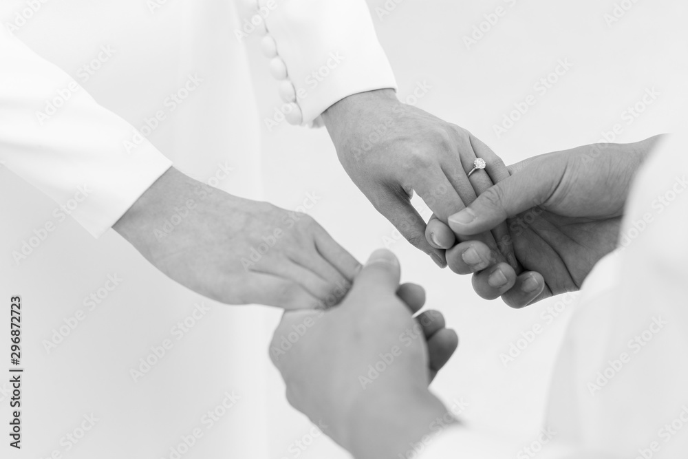 Fototapeta premium Black and white The groom holds the hands of the bride.text space.marry me !