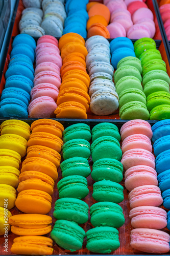 Vertical photo of colorful handmade macaroon cakes in patisserie 