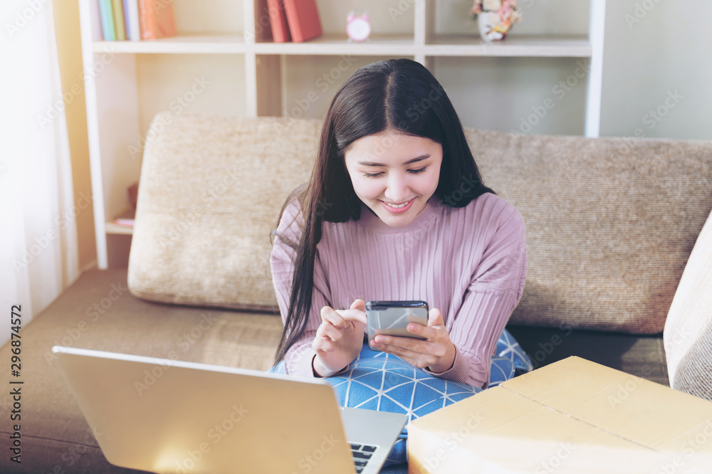 Cheerful young pretty woman use smartphone in living room Cheerful young pretty woman use smartphone in living room