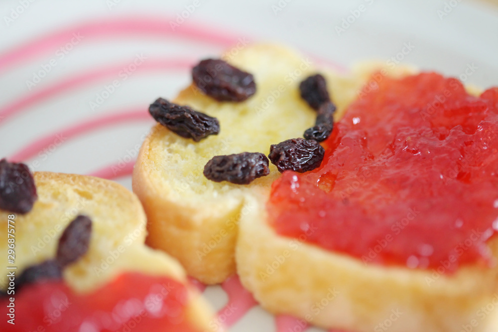 Toast and strawberry jam with currant , smile face toast