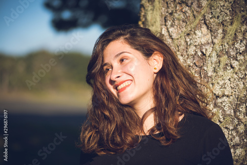 Pretty woman 20s big smile, headshot outdoors 