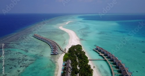 Long rows of luxury bungalows on tropical island shore of Pulau Sebatik, Malaysia photo