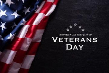 Happy Veterans Day. American flags veterans against a blackboard background.