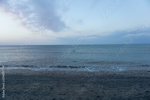 The evening sea watching Buddha amulet falling on the beach