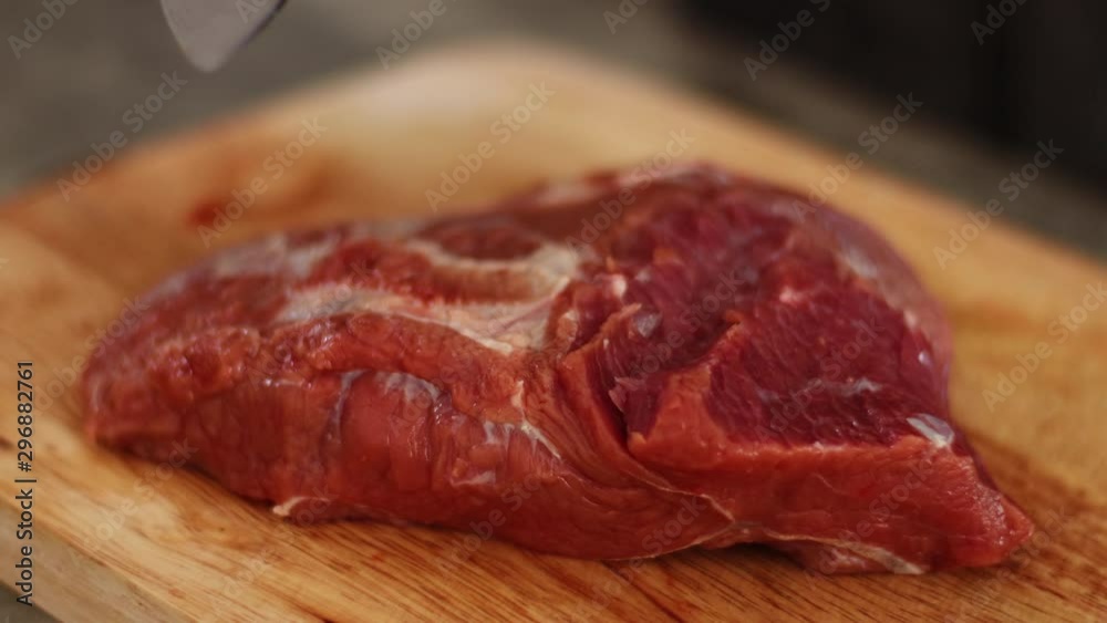 4k man wearing white glove slowly slicing red raw bee steak, on wooden slice board, daylight, sharp small knife, black apron, chef prepare meat before cooking, steak, bbq, meat, human hand 4k man wearing white glove slowly slicing red raw bee steak, on wooden slice board, daylight, sharp small knife, black apron, chef prepare meat before cooking, steak, bbq, meat, human hand