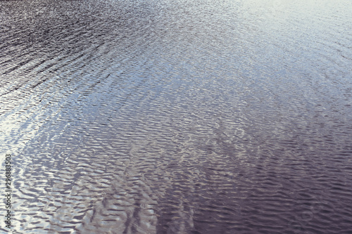 Wavy water surface of lake or river ripple background