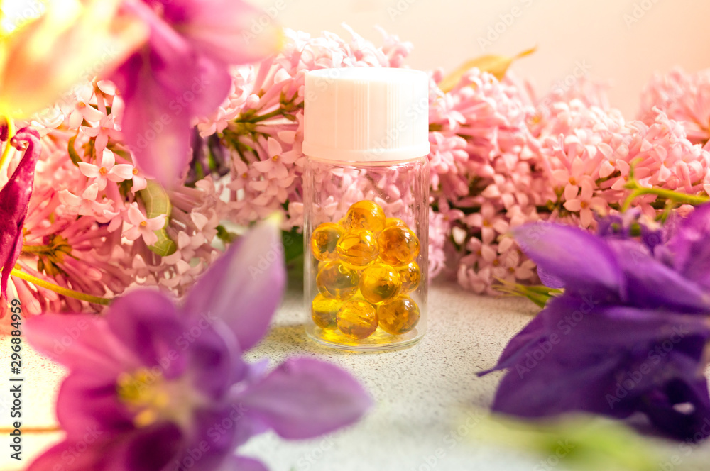 a jar with fish oil capsules and purple liliac flowers