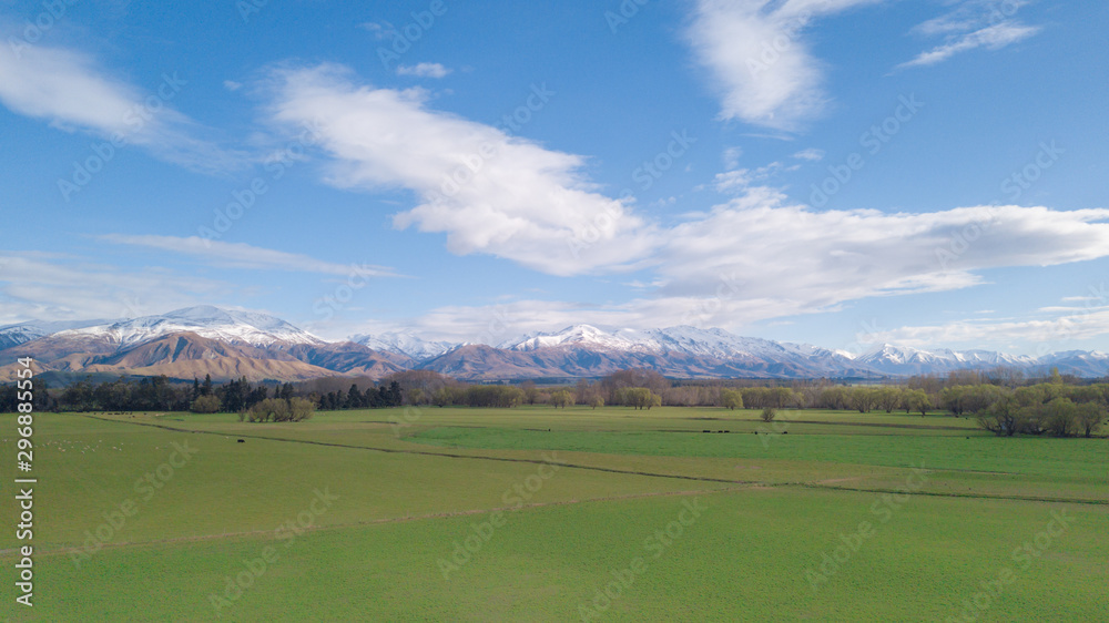 Amazing aerial view of green field with snowcap mountain in background.Aerial Panoramic view of Mount Cook in New Zealand.