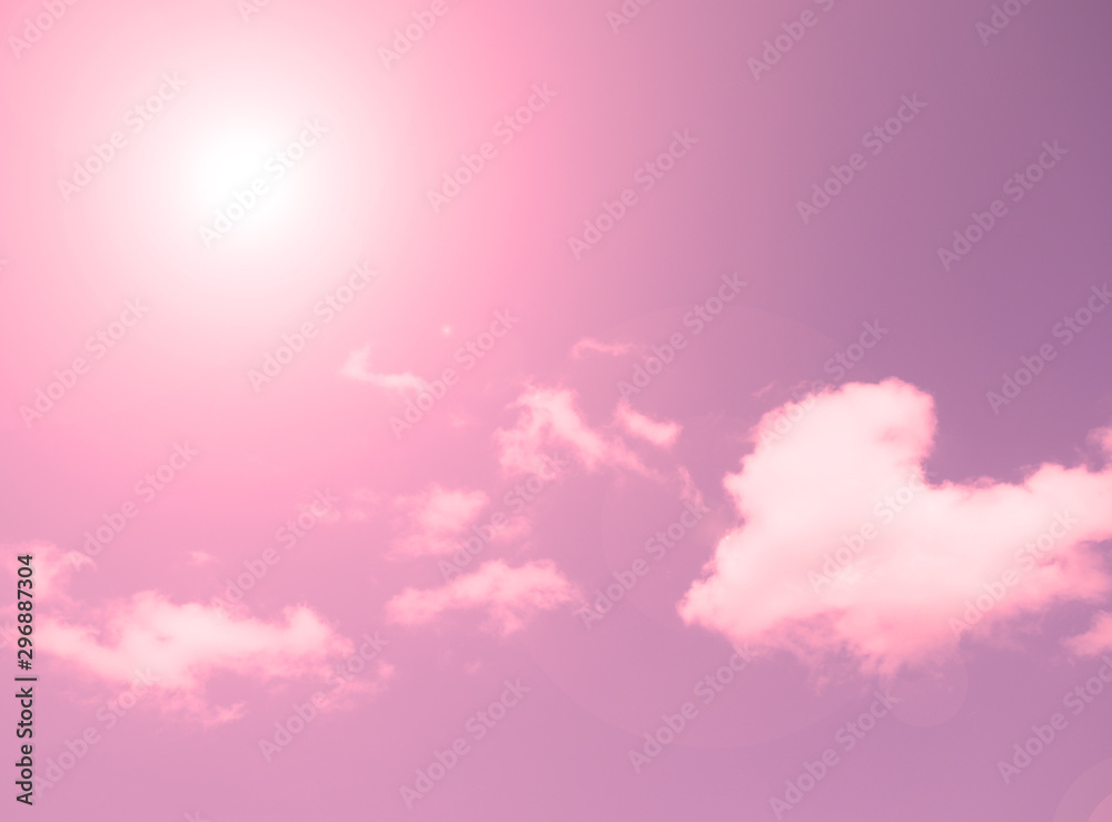 Bright sun shines against the sky with white clouds. Background, texture.