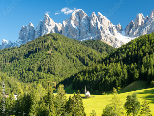 Famous St Johann Church and Odle Mountain peaks in the background. Santa Maddalena, South Tyrol, Italy. September 2017 photo