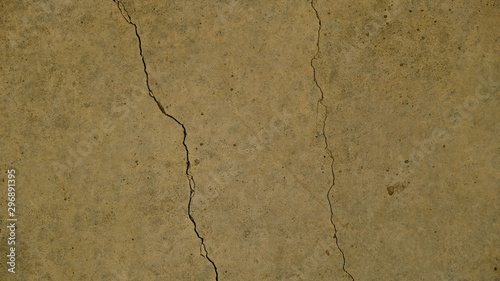  A crack on the concrete wall surface of a house in Los Angeles. Background image for your design