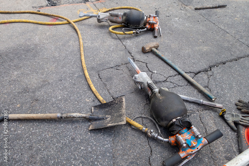 street tarmac with high powered jack hammers and other hand tools