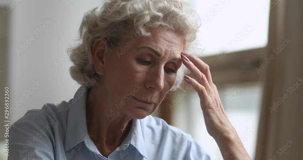 Sad thoughtful older woman worried about health problems at home Sad thoughtful older woman worried about health problems at home