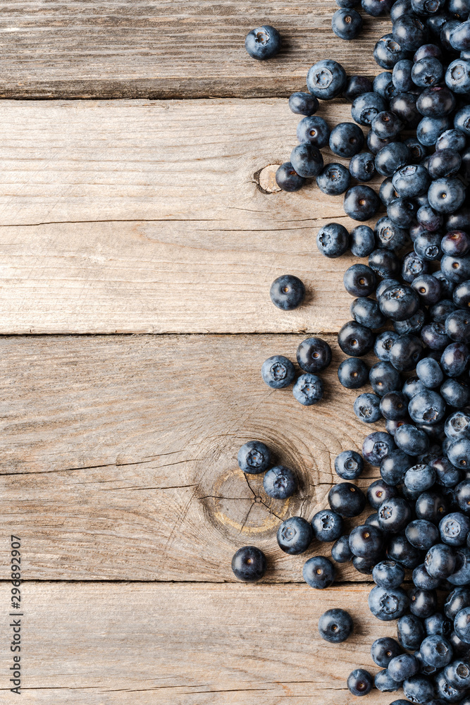 Overhead shot of tasty blueberries on wooden background with copyspace. Top view Overhead shot of tasty blueberries on wooden background with copyspace. Top view