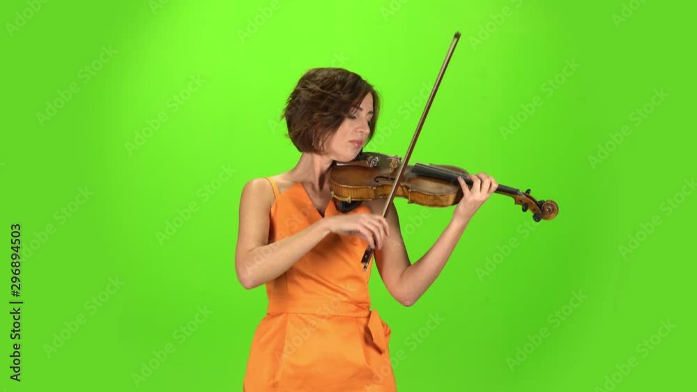 Musician in the studio plays the violin. Green screen Musician in the studio plays the violin. Green screen