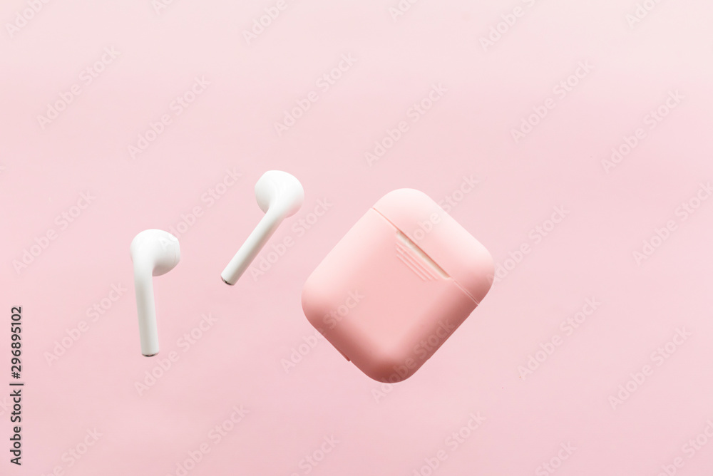 wireless headphones and pink case on pink background wireless headphones and pink case on pink background