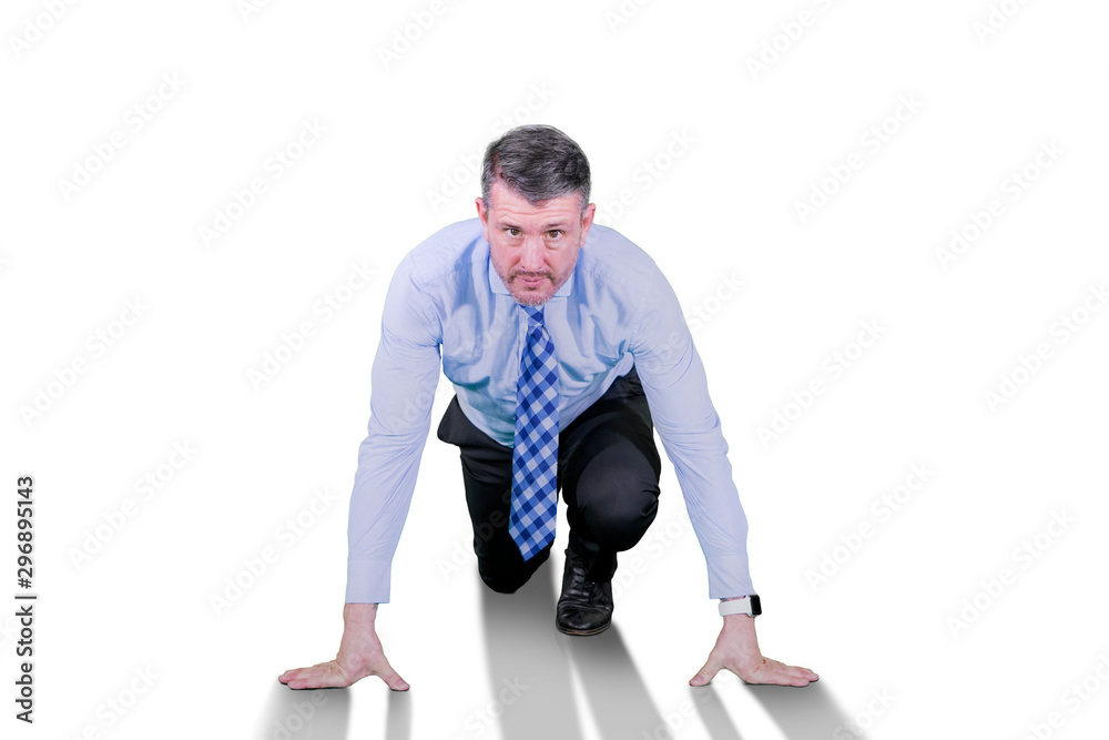 Caucasian businessman in ready position to run Caucasian businessman in ready position to run