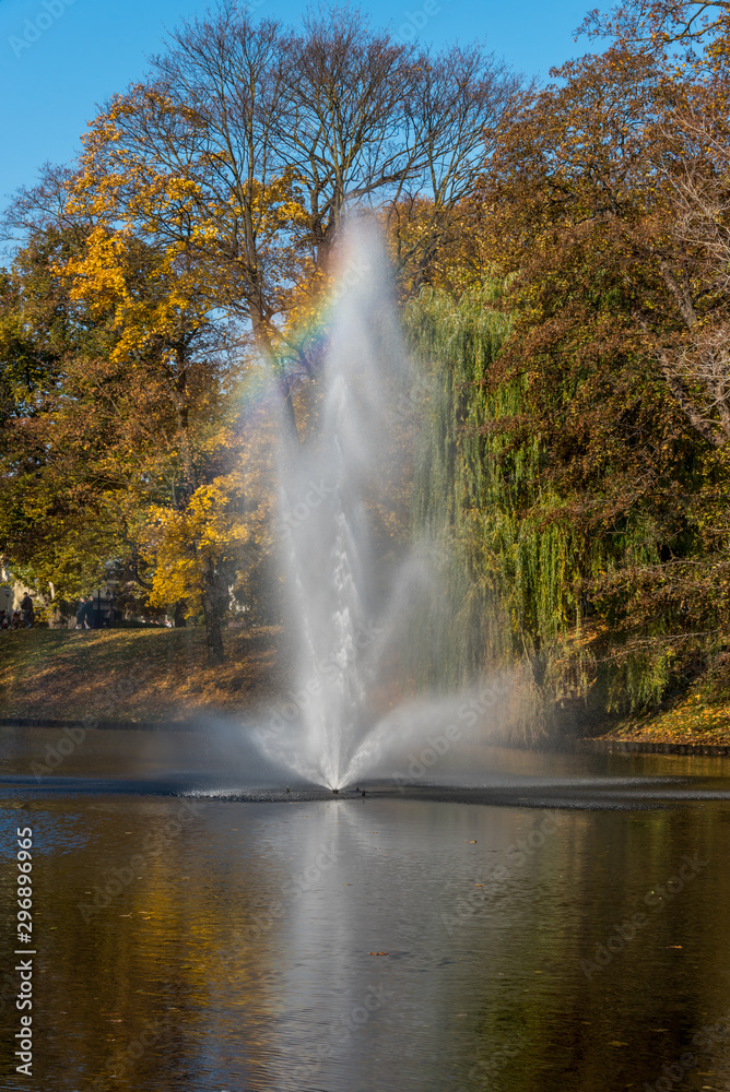 Rainbow in a Fountain's Spray on a Sunny Day in Autumn