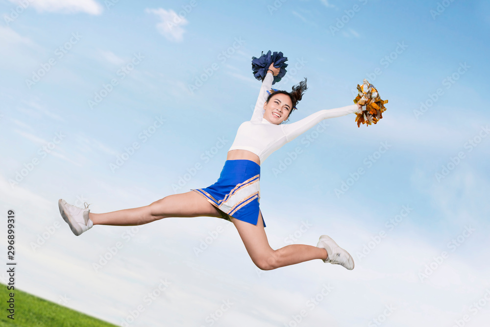 Low angle view of cheerleader performs in the park Low angle view of cheerleader performs in the park