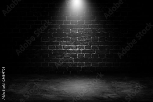 Abstract image of Spot lighting with black brick wall in background.