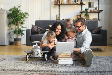 Young beautiful happy family relaxing at home