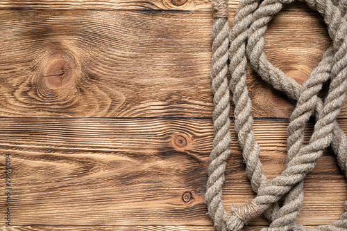 Rope on brown wooden floor background with copy space.