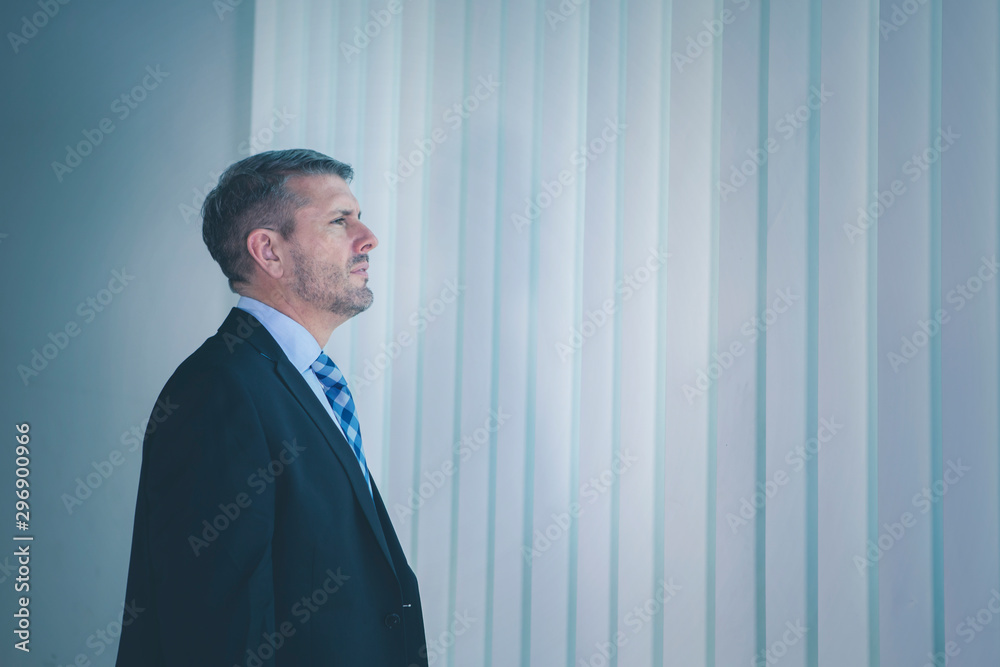 Side view of pensive businessman near the window Side view of pensive businessman near the window