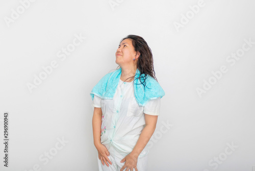 An Asian girl in blue pajamas is looking up  and smiling to the blank space over her head. photo