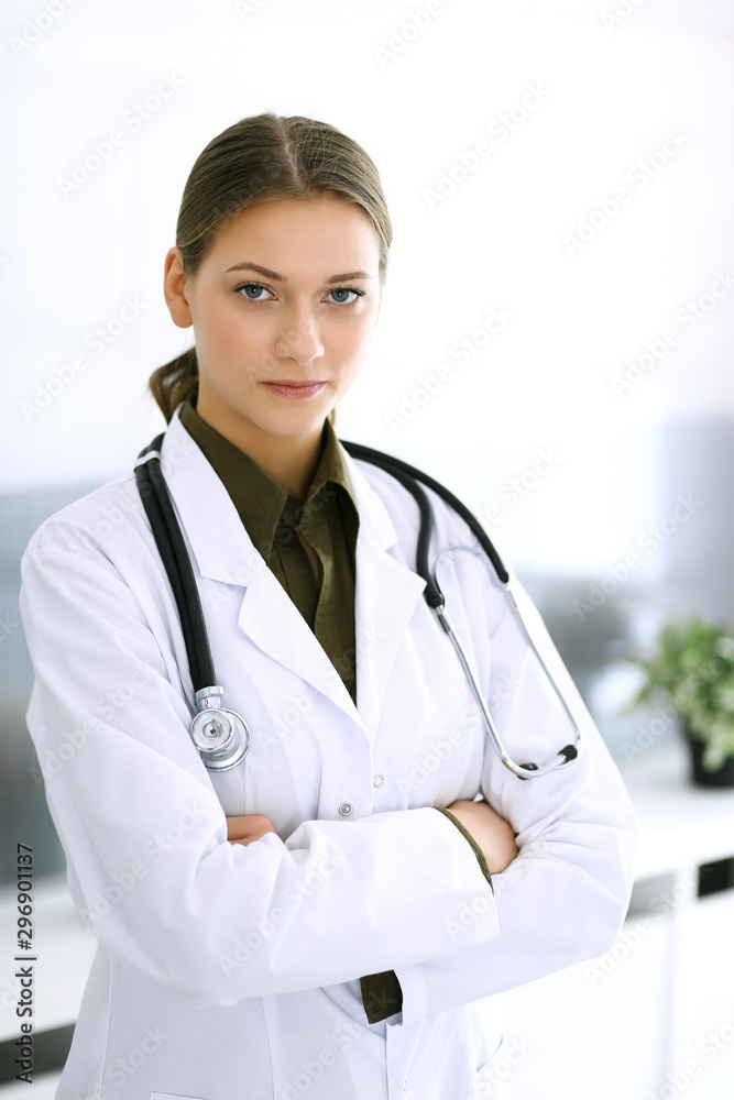 Doctor woman standing straight and looking at camera. Perfect medical service in clinic. Happy future in medicine and healthcare