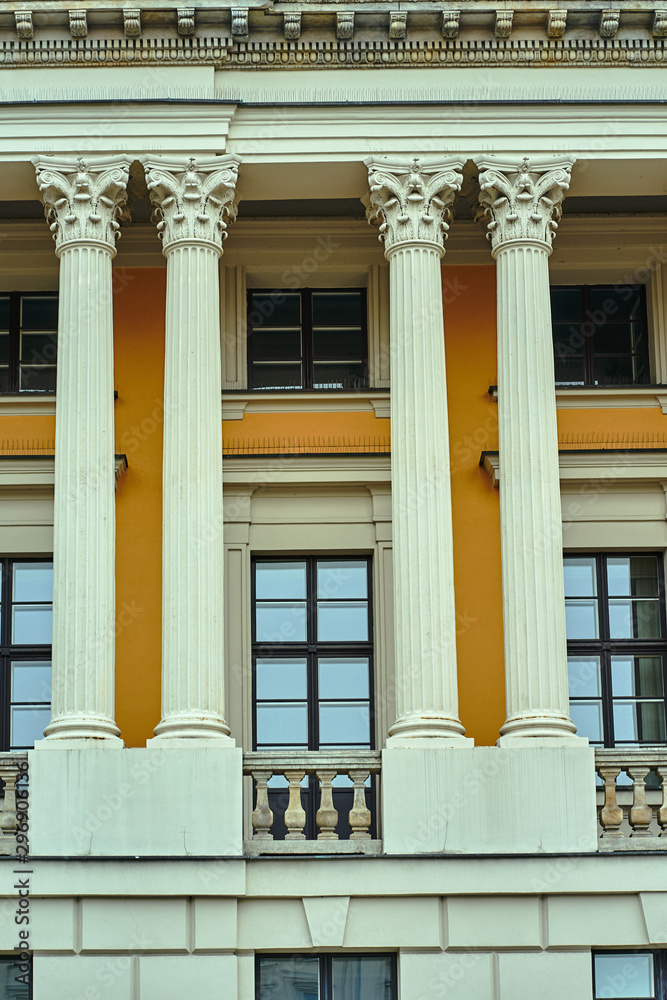 A fragment of the facade of a historic building with Corinthian columns in Poznan.