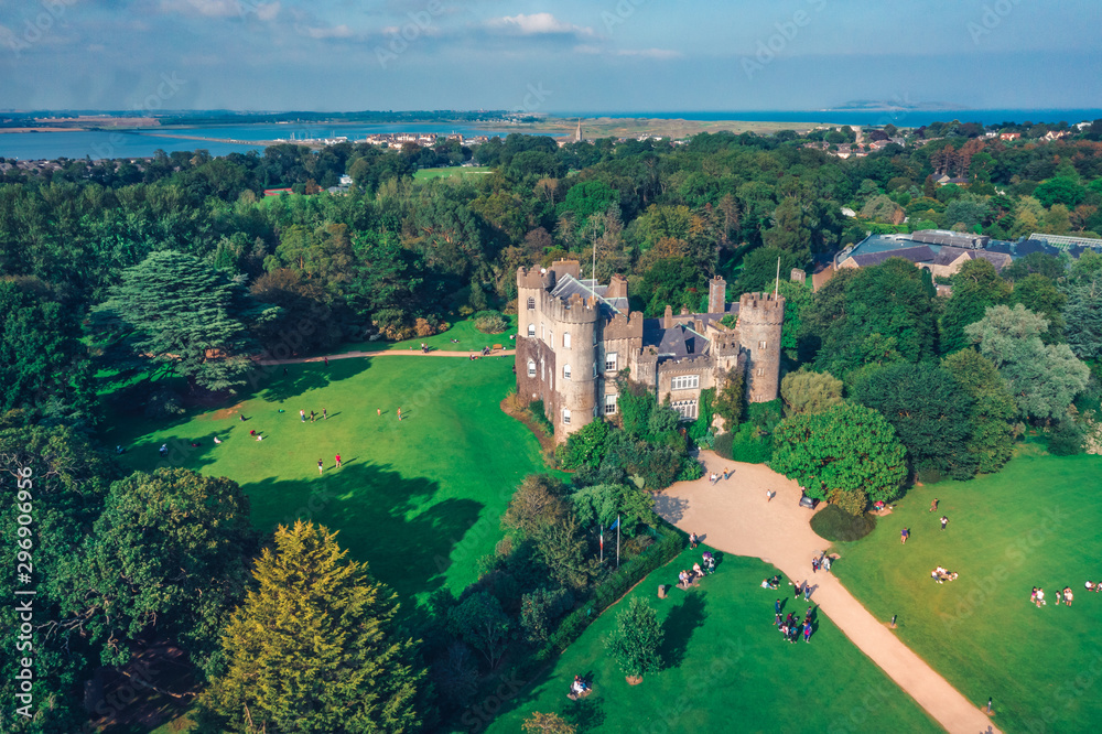 Fototapeta premium Aerial drone view of the Malahide castle in Dublin, Ireland. The castle, along with its subsidiary attractions, was for many years operated as a tourist attraction by Dublin Tourism